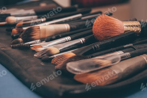 Preview: Closeup shot of cosmetic brush set on the black leather pad