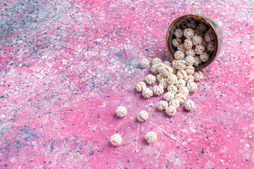 Preview: front view white sweet confitures on the pink background candy sugar sweet tea color bonbon
