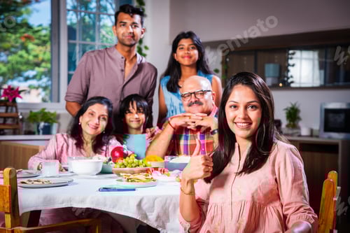 Preview: Happy Indian asian family having lunch at home and posing for photo