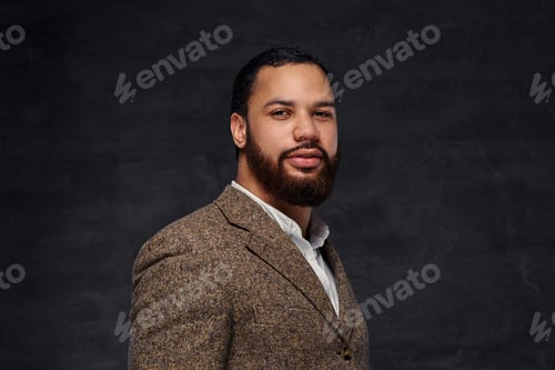 Preview: Handsome bearded African-American businessman in a brown classic jacket.