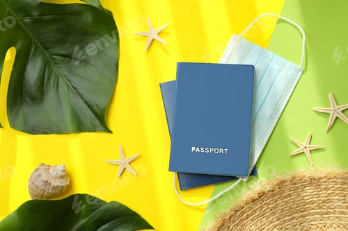 Preview: Passports with mask and vacation accessories on color background