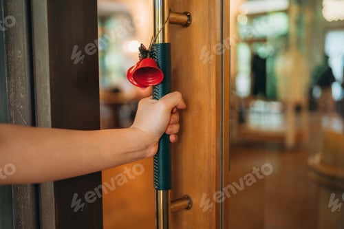 Preview: Hand opening wooden door with golden handle, symbolizing opportunity and welcome.
