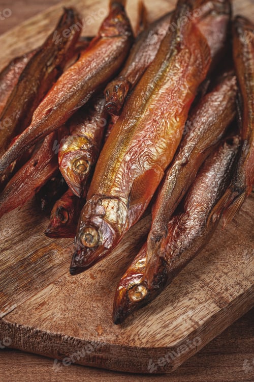 Preview: cold smoked capelin, on a wooden chopping board, no people,