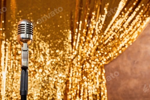 Preview: Silver retro icrophone against the background of a sparkling golden curtain