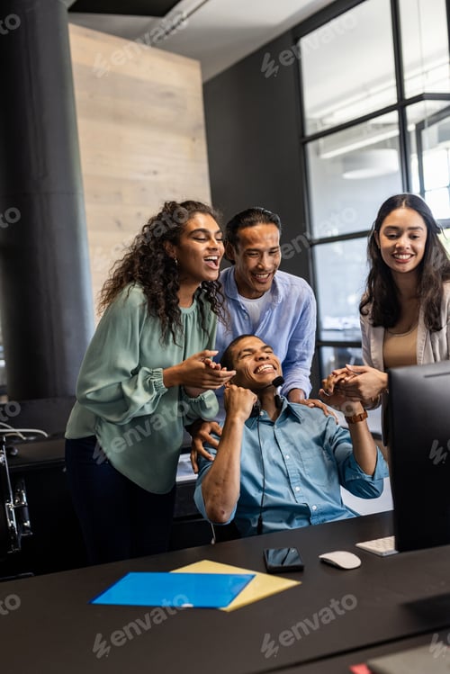 Preview: Diverse business team celebrating success together in modern office environment