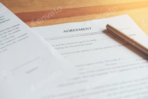 Preview: closeup of signing a documentation agreement and pen on the table.