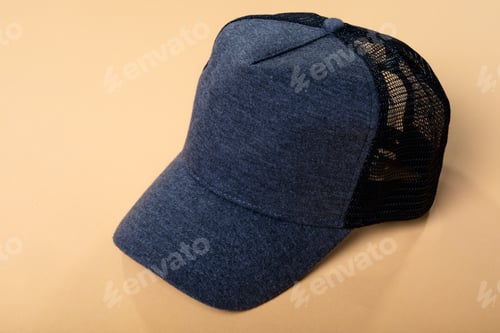Preview: Composition of close up of grey and black baseball cap with mesh back on yellow background