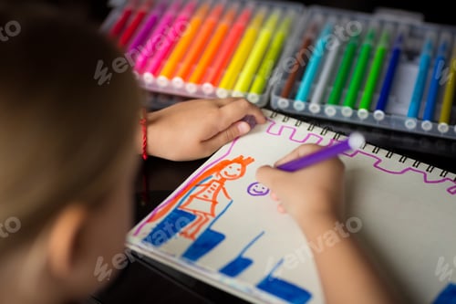 Preview: Child painting princess with colored pencils on paper blank