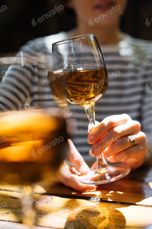Preview: Woman holding glass of wine