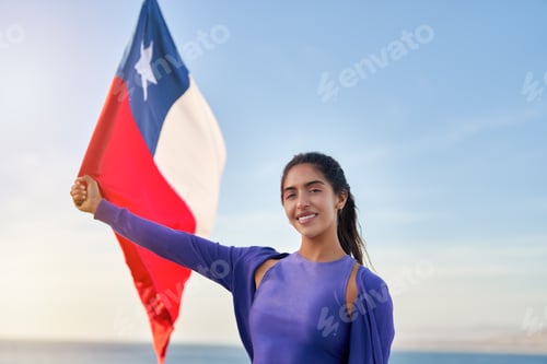 Preview: Woman Holding Flag on Beach with Blue Sky