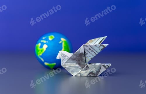 Preview: An origami bird folded from a US dollar bill and a globe.