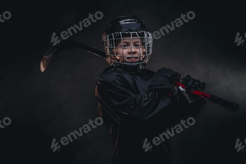 Preview: Young hockey player posing in uniform for a photoshoot in a studio