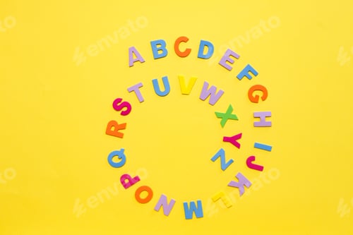 Preview: Back to school concept. Alphabet. Colourful letters on yellow background.