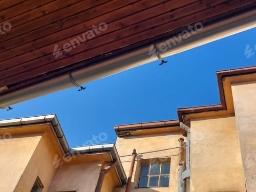 Preview: Architectural detail, of old urban building wall against blue sky