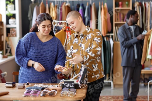 Preview: Two Female Customers Choosing Fashion Accessories at Thrift Store