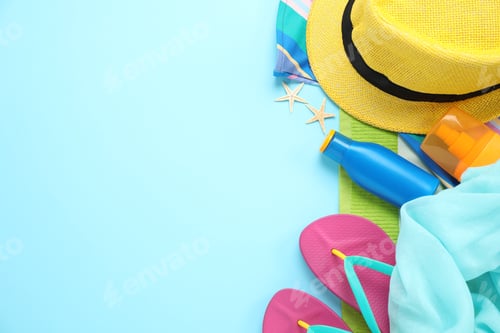 Preview: Flat lay composition with beach accessories on light blue background, space for text