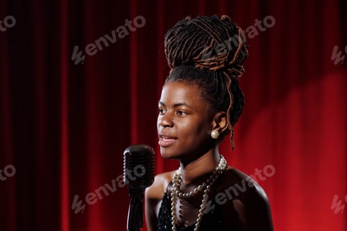 Preview: Portrait of Young Adult Black Woman Singing Jazz Music into Vintage Microphone