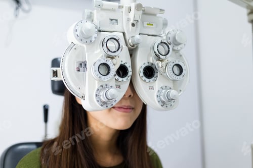 Preview: Woman doing eye test in medical office