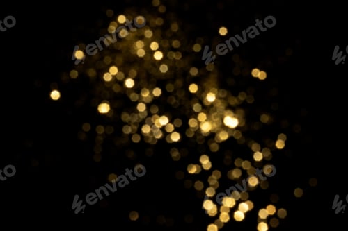 Visualização: Luzes bokeh douradas desfocadas em fundo preto