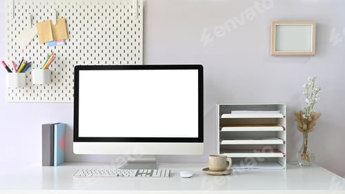 Preview: A workspace computer monitor is putting on a white working desk surrounded by office equipment.