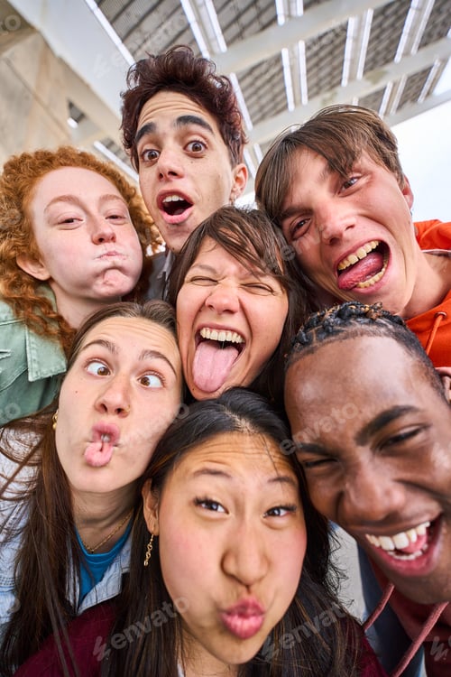 Preview: Vertical multi-ethnic group of crazy students boys and girls taking selfie outdoors.