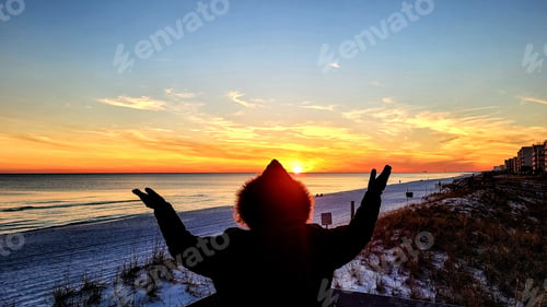 Preview: Woman from behind in emotional and inspirational moments at sunset in Florida gulf coast.