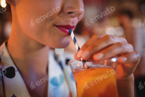 Preview: Close-up of woman having cocktail drink