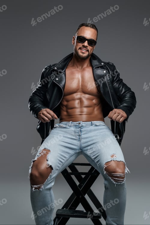 Preview: Handsome male model with muscular shirtless torso flashes a wide smile