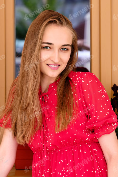 Preview: Happy girl resting in cafe terrace with glass of icy beverage