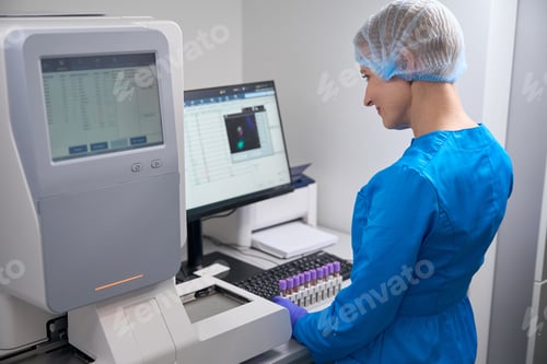 Preview: Woman laboratory assistant enters work data into the database