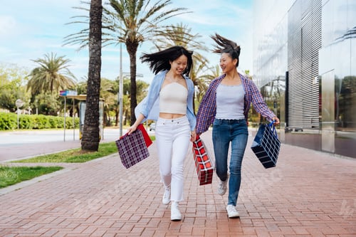 Preview: Happy beautiful chinese women friends bonding in the city