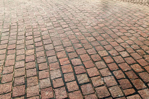 Preview: Stone pavement in perspective. Stone pavement texture. Granite cobblestoned pavement background