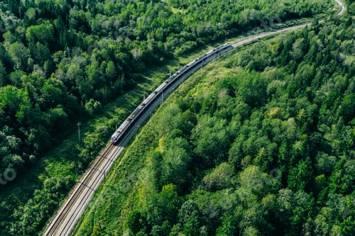 Preview: Aerial drone view of train in beautiful green summer forest. Train moving to railway station