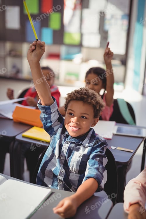 Preview: Schoolkids raising their hands in classroom