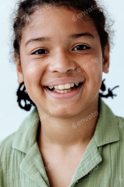 Preview: Cheerful young african american boy in green shirt exuding confidence and happiness with a trendy