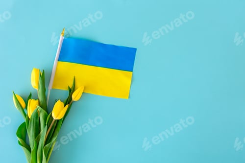 Preview: Flat lay composition with a bouquet of yellow tulips, the flag of Ukraine.