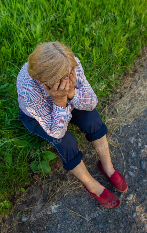 Preview: Old woman feels bad on the street, headache. Selective focus.