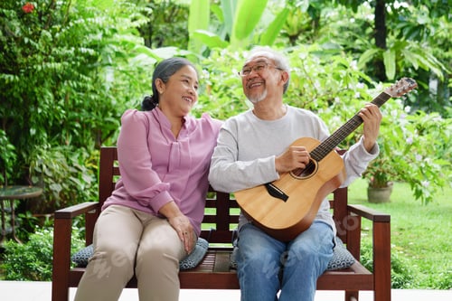 Preview: Happy senior grandparents playing guitar and singing songs having fun