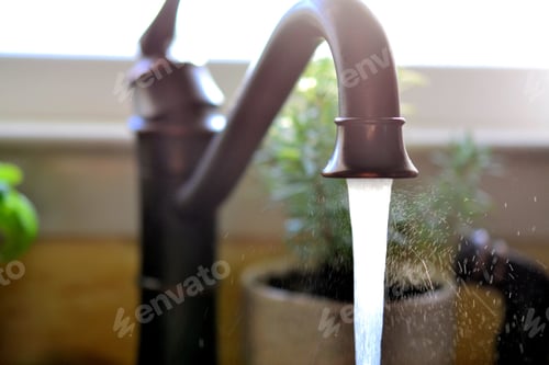 Preview: Kitchen Sink Faucet with running, spraying water with a window and herbs herb plants