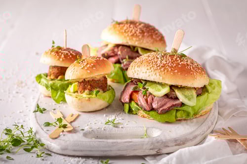 Preview: Four Burgers With Meat on a Serving Board