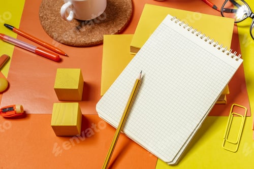 Preview: Workspace setup with notebook, tools, and coffee cup on colorful table