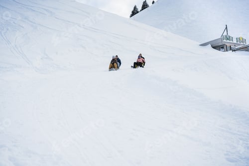 Preview: Crazy happy friends having fun with sledding on snow high mountains