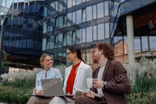 Preview: Engaging in Team Collaboration Outdoors While Using Laptops and Enjoying Coffee Beverages