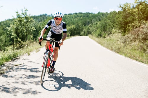 Preview: Men cycling mountain road at morning