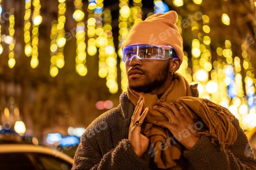 Preview: African man wearing smart glasses during a Christmas city night