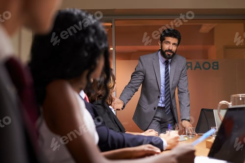 Preview: Businessman addressing team at a meeting, low angle close up