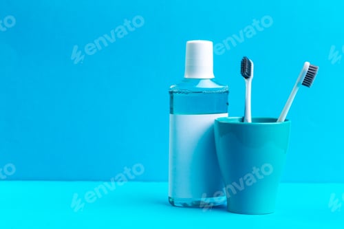 Preview: Toothbrushes in glass on the table. creative photo.
