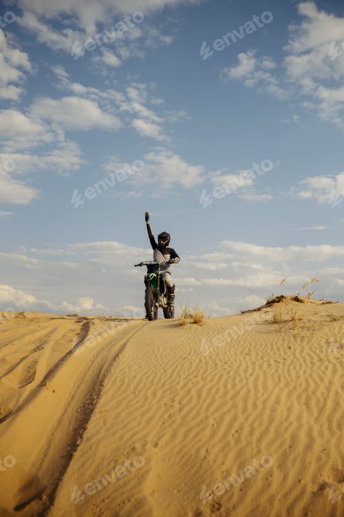 Preview: Motorcross rider with raised hand front view