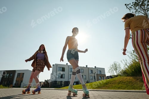 Preview: Young fit woman in roller skates listening to music in headphones and skating