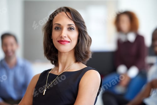 Preview: Portrait of an attractive businesswoman with coworkers in the background